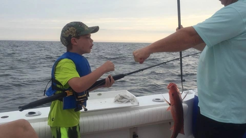 boy-catches-red-snapper-fish